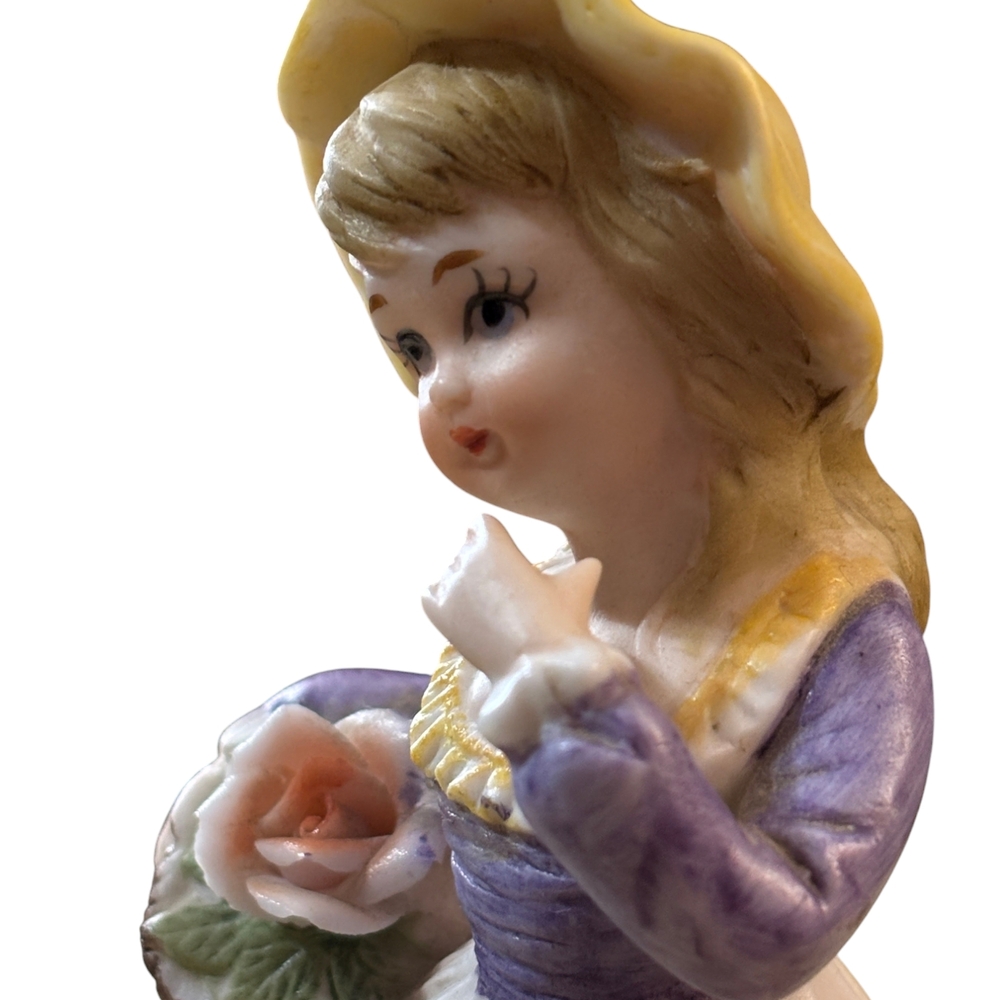 Porcelain Figurine with Purple Dress and Yellow Hat